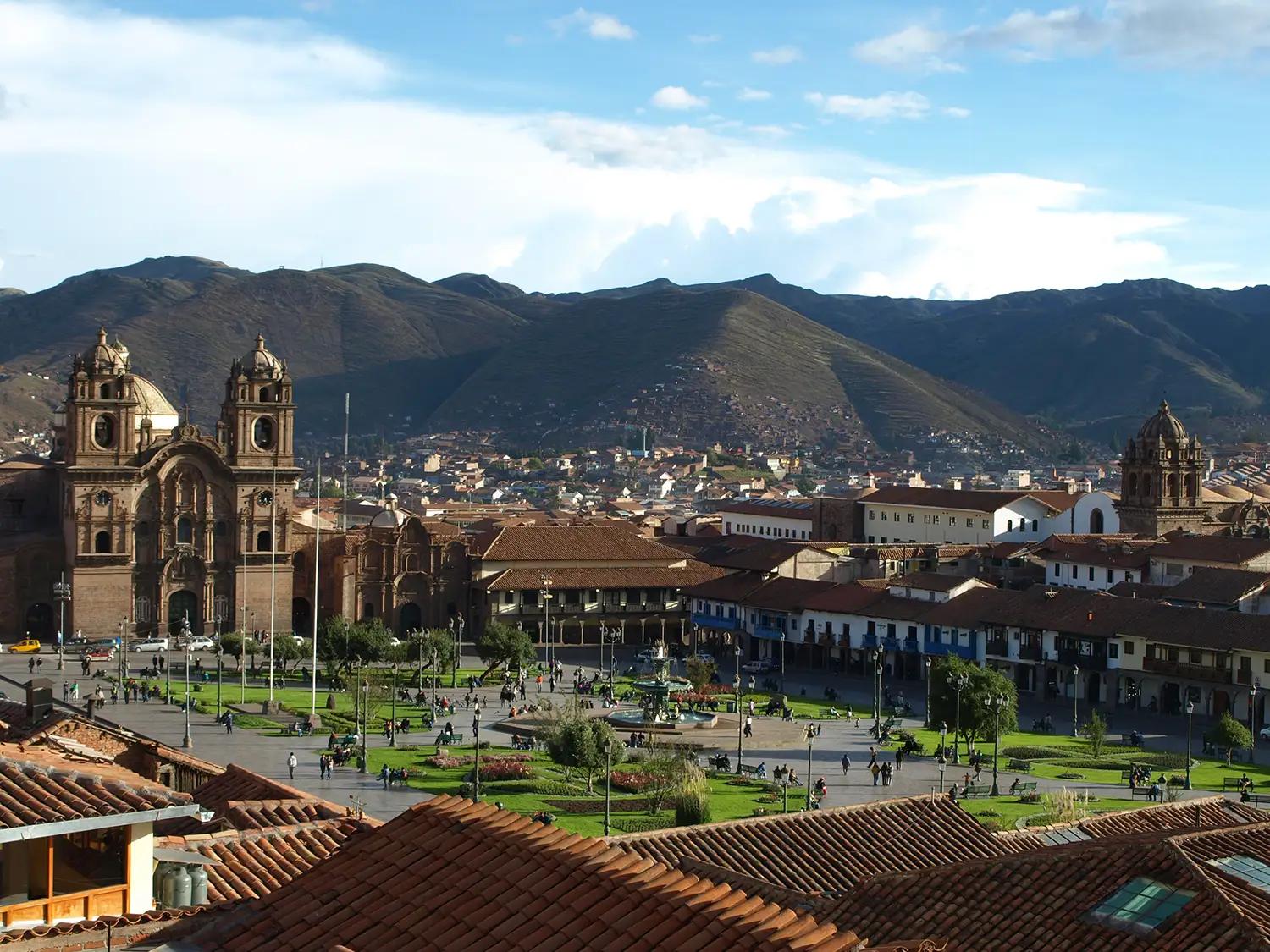 Cityscape of medieval church and houses with old tile roof in Cusco Peru.