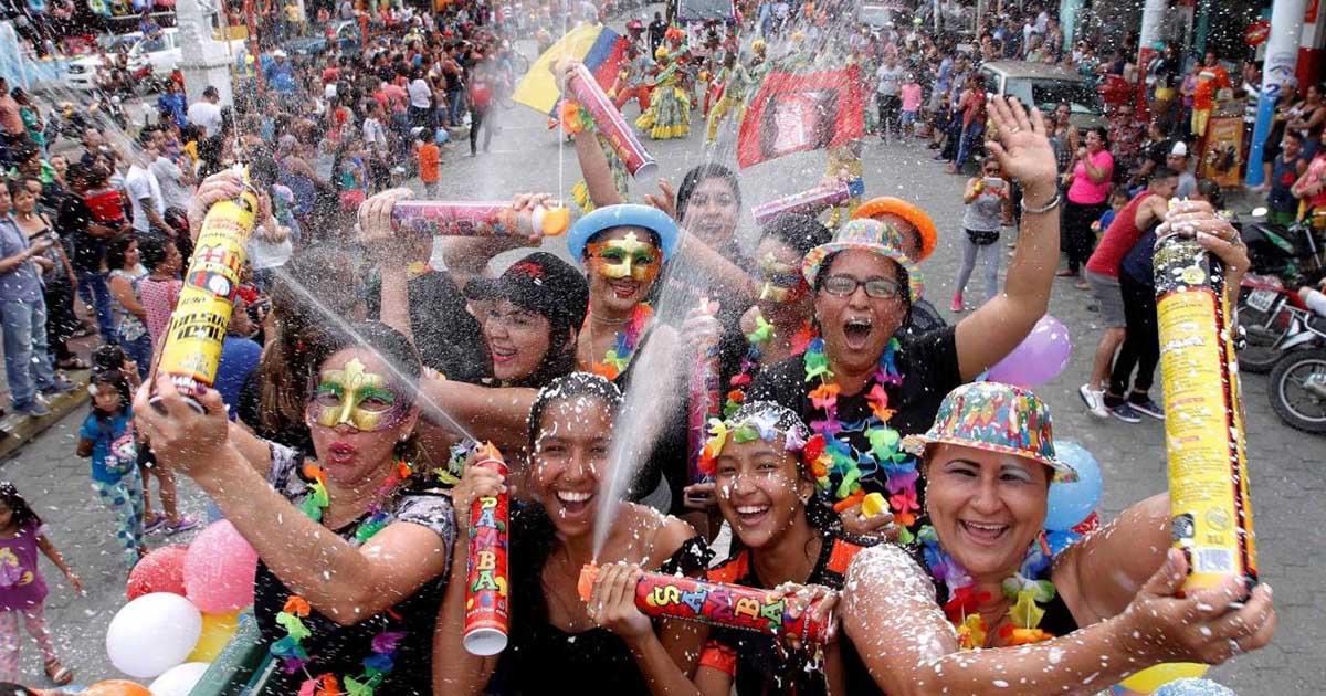 Festival goers with spray foam at Carnaval in Ecuador. Photo by El Universo.
