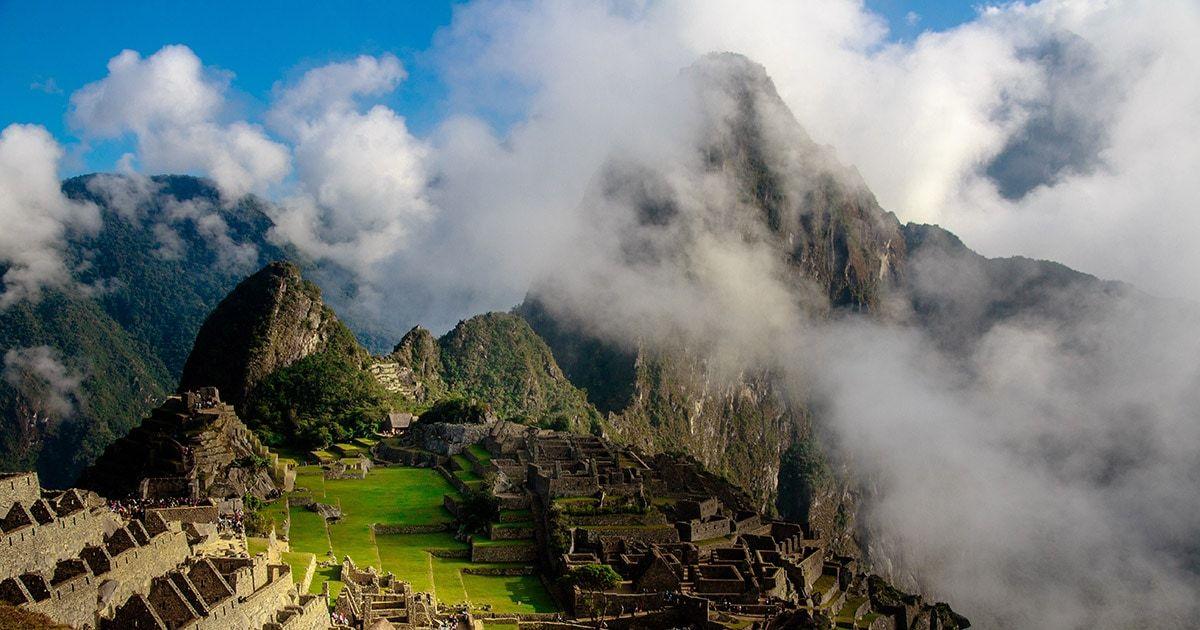 Machu Picchu peaking through some clouds. Photo by Scott Umstattd on Unsplash.