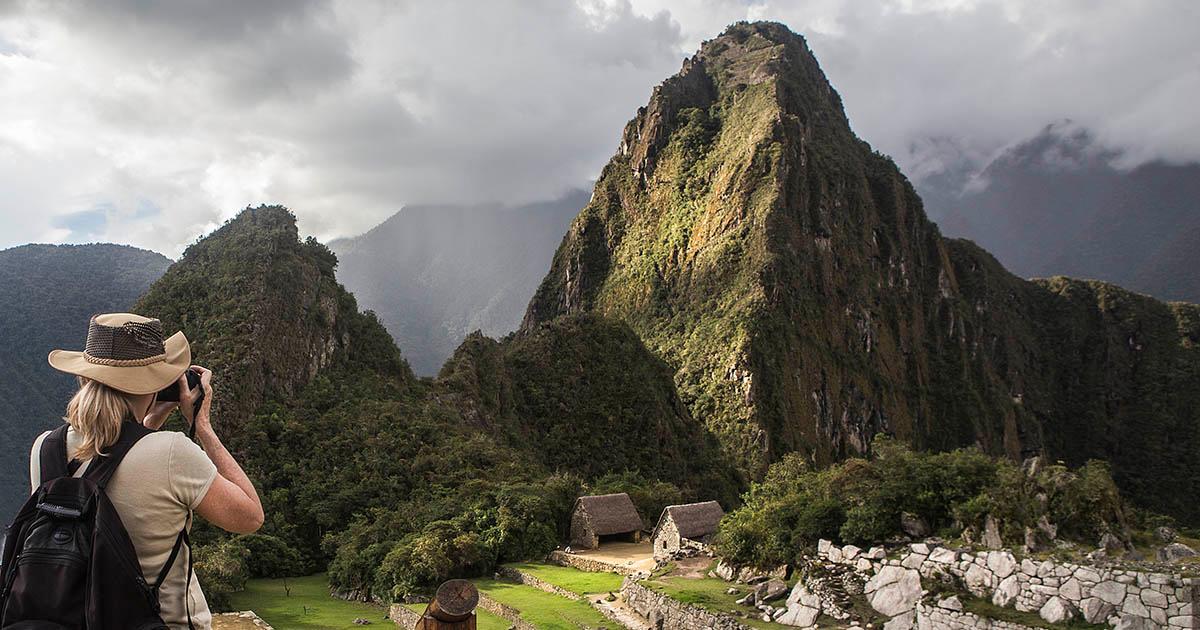 A tourist takes photos of Machu Picchu.