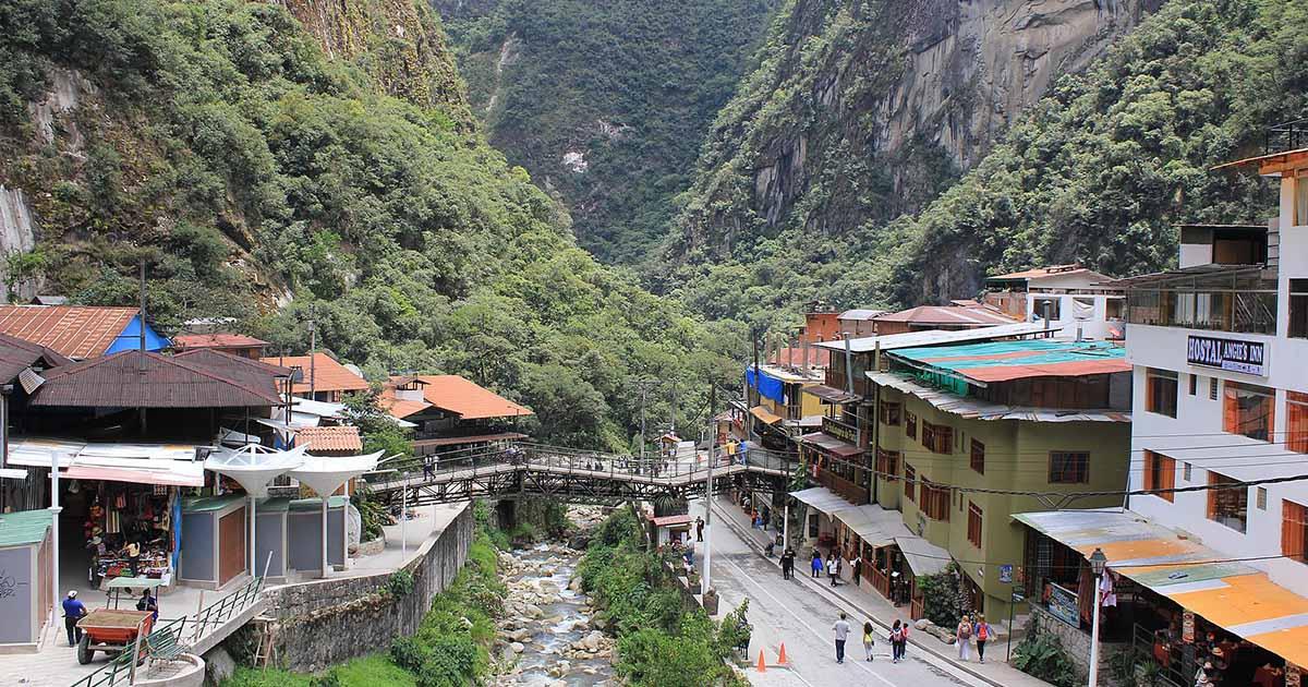 The town of Aguas Calientes is abuzz with travelers excited to visit Machu Picchu. Image: Machu Picchu, Peru - Laslovarga (262) by Laslovarga, used under CC BY-SA 4.0 / Cropped and compressed from original.