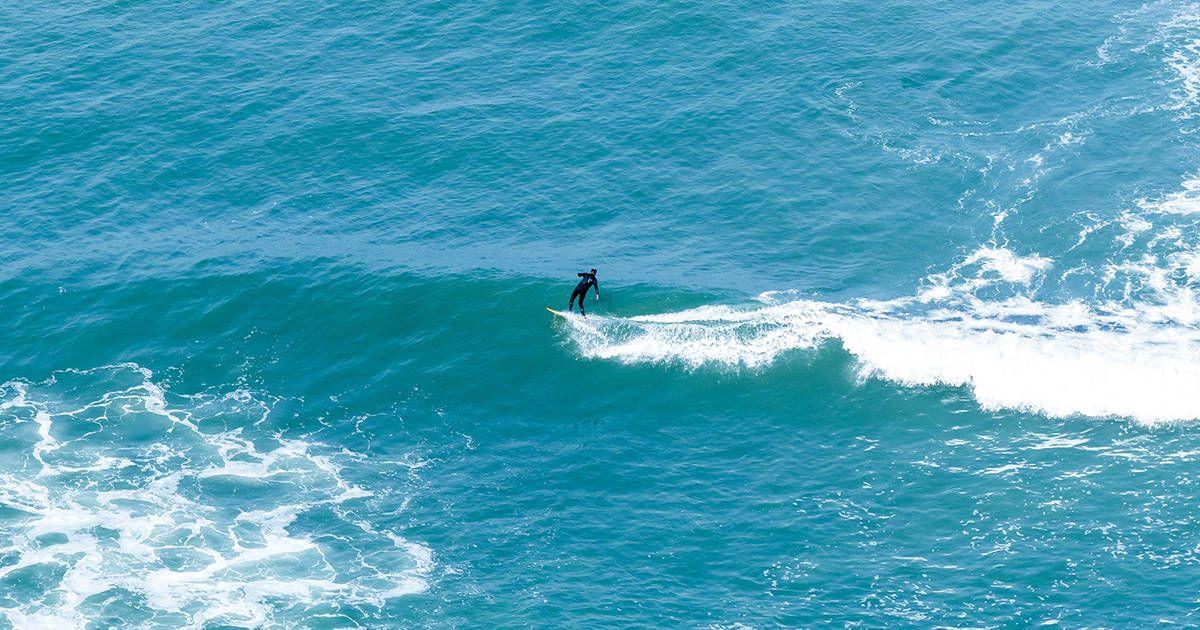 A surfer catching some waves in Lima. Photo by Willian Justen de Vasconcellos on Unsplash.