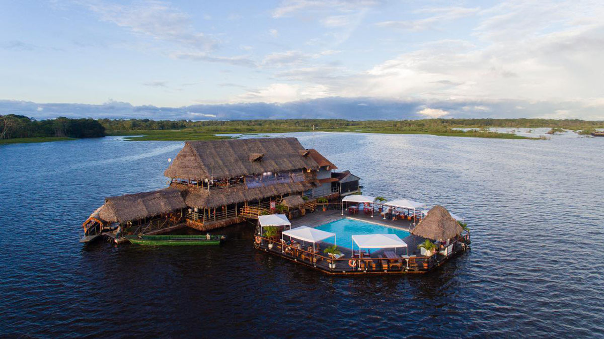 A rustic restaurant with a pool floating on the Amazon River in Iquitos, Peru