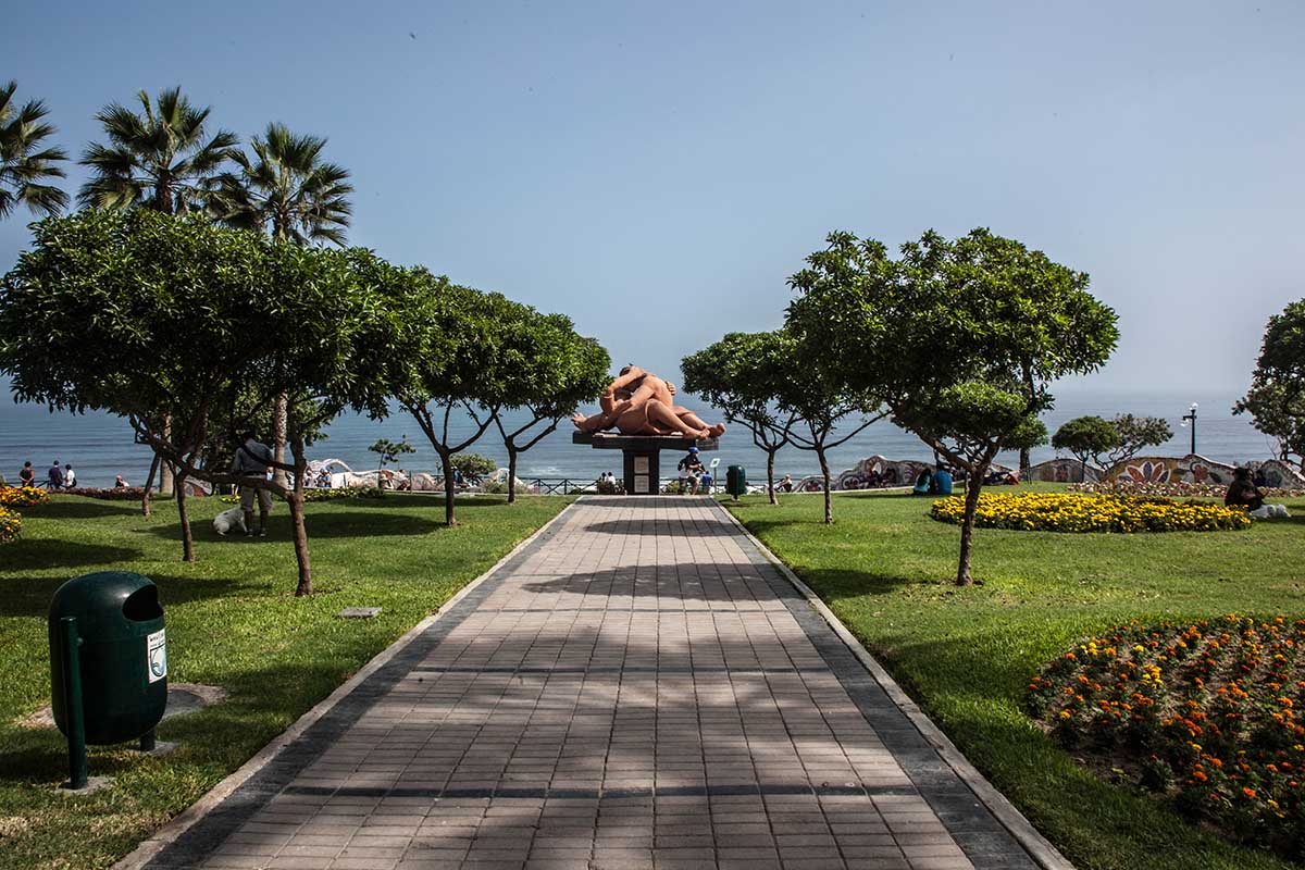 A walkway at Parque del Amor in Lima passes by manicured gardens and overlooks the El Beso statue.