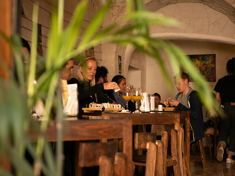 Interior shot of people eating at El Buda Profano restaurant in Arequipa