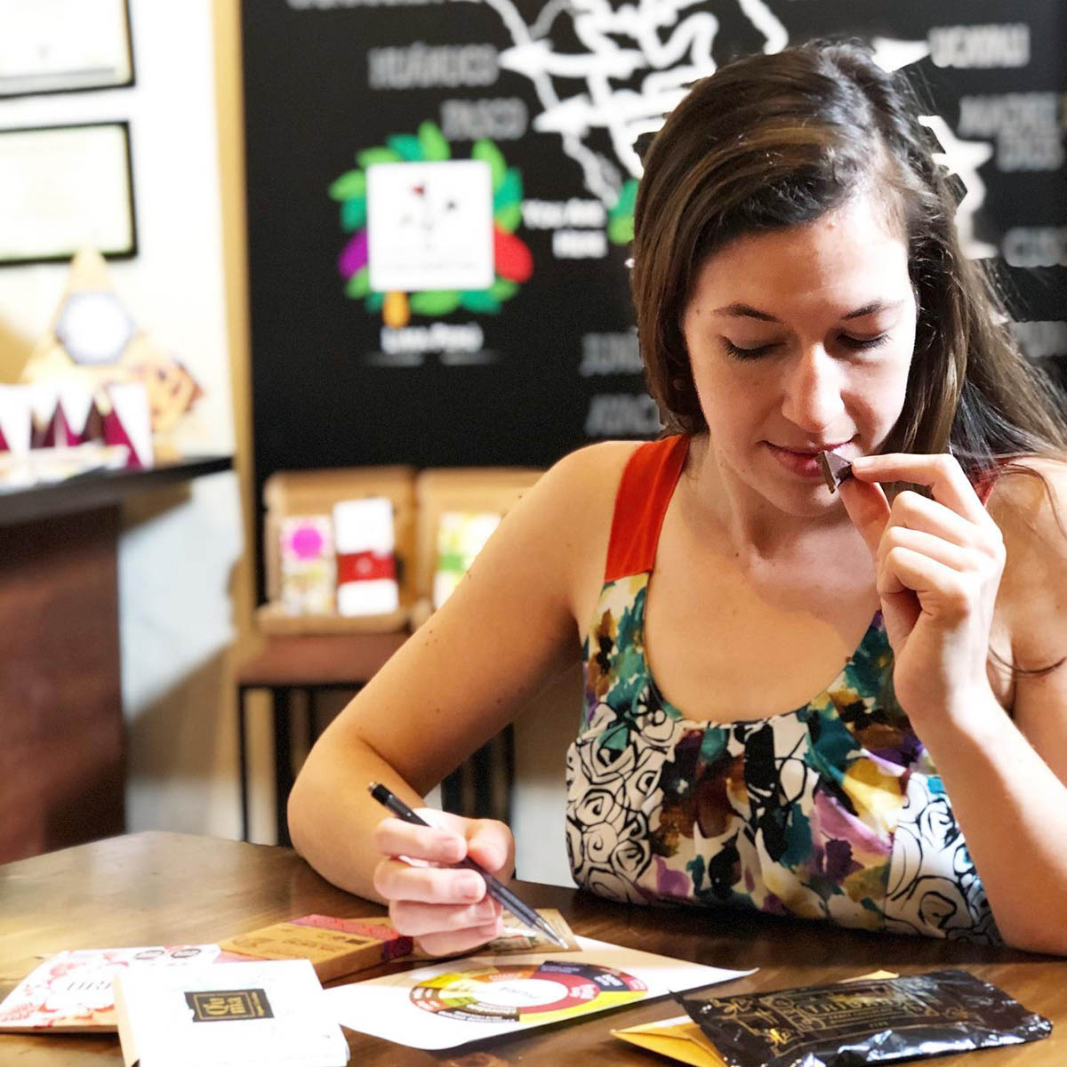 Women sampling different types of Peruvian chocolate at El Cacaotal cacao boutique in Lima.