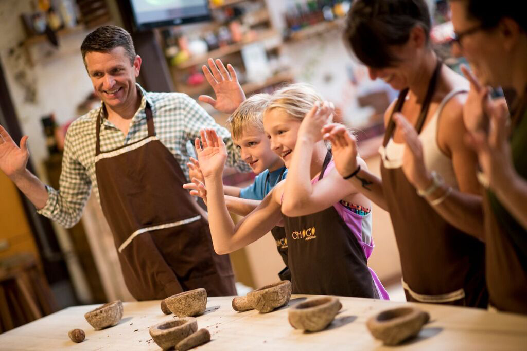 Family of 4 enjoying a chocolate-making workshop at ChocoMuseo, a popular chocolate museum in Peru