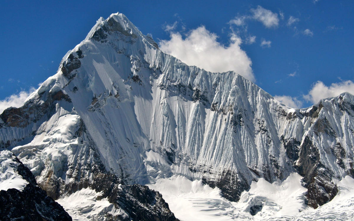 Steep snow-covered peak of the Yerupaja Mountain, which can be see on the Huayhuash Circuit Hike.