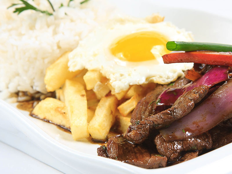 Lomo saltado, a Peruvian dish consisting of beef, peppers, onions, and tomatoes with french fries.