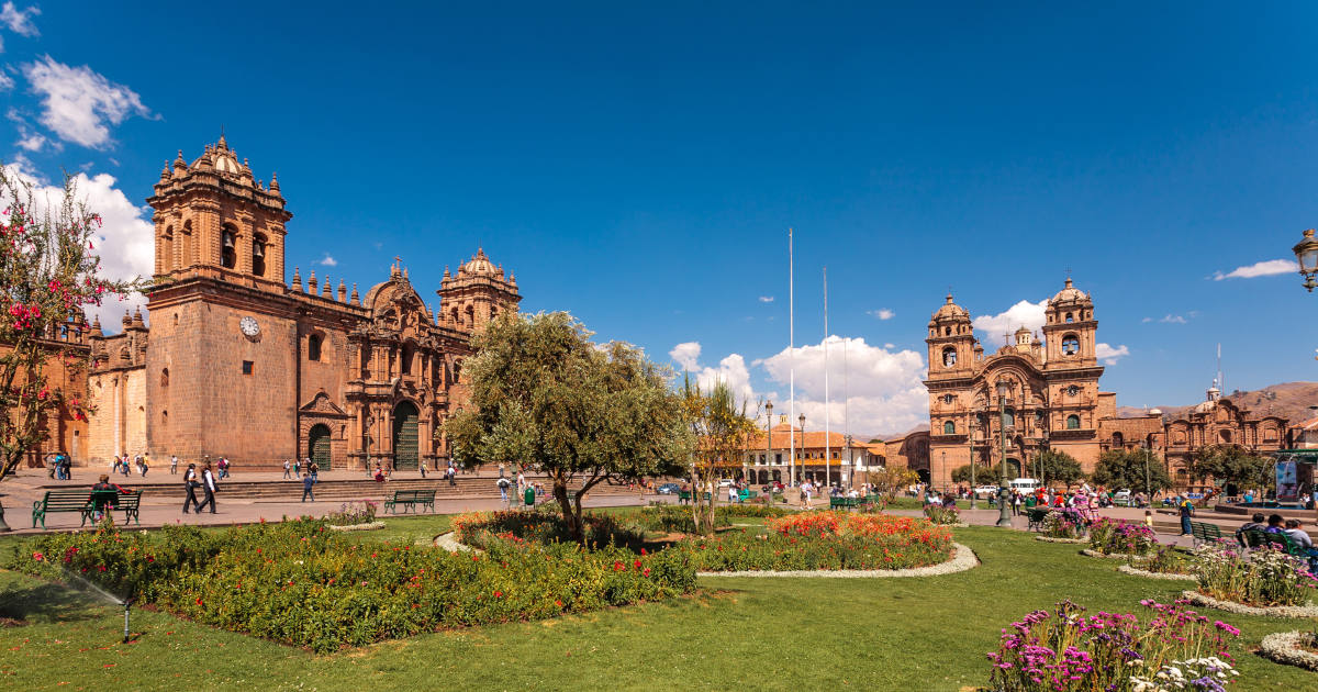 The Plaza de Armas and Cusco Cathedral of Cusco, Peru on a clear blue day.
