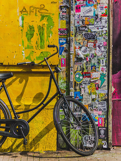Bike against a painted and graffiti'd wall in Lima