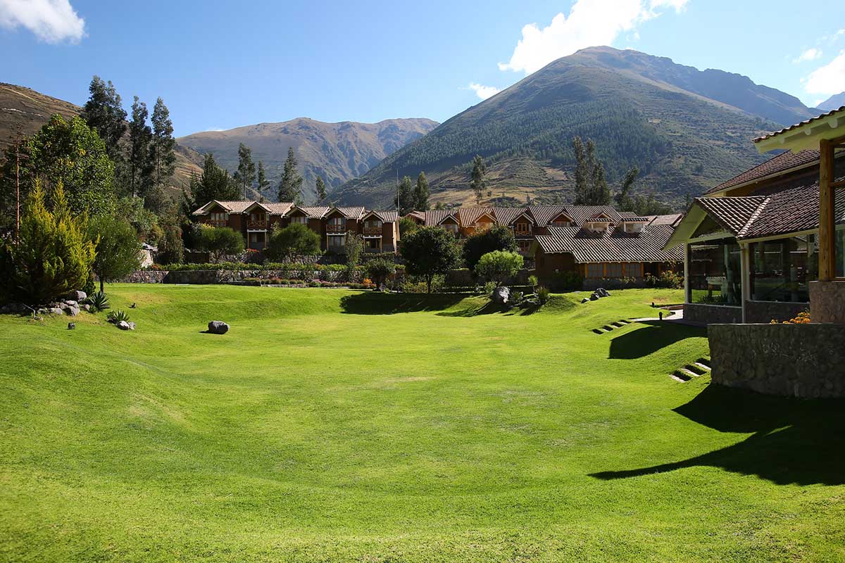 Green grounds, blue skies and mountains of Casa Andina Premium Luxury Hotel in the Sacred Valley