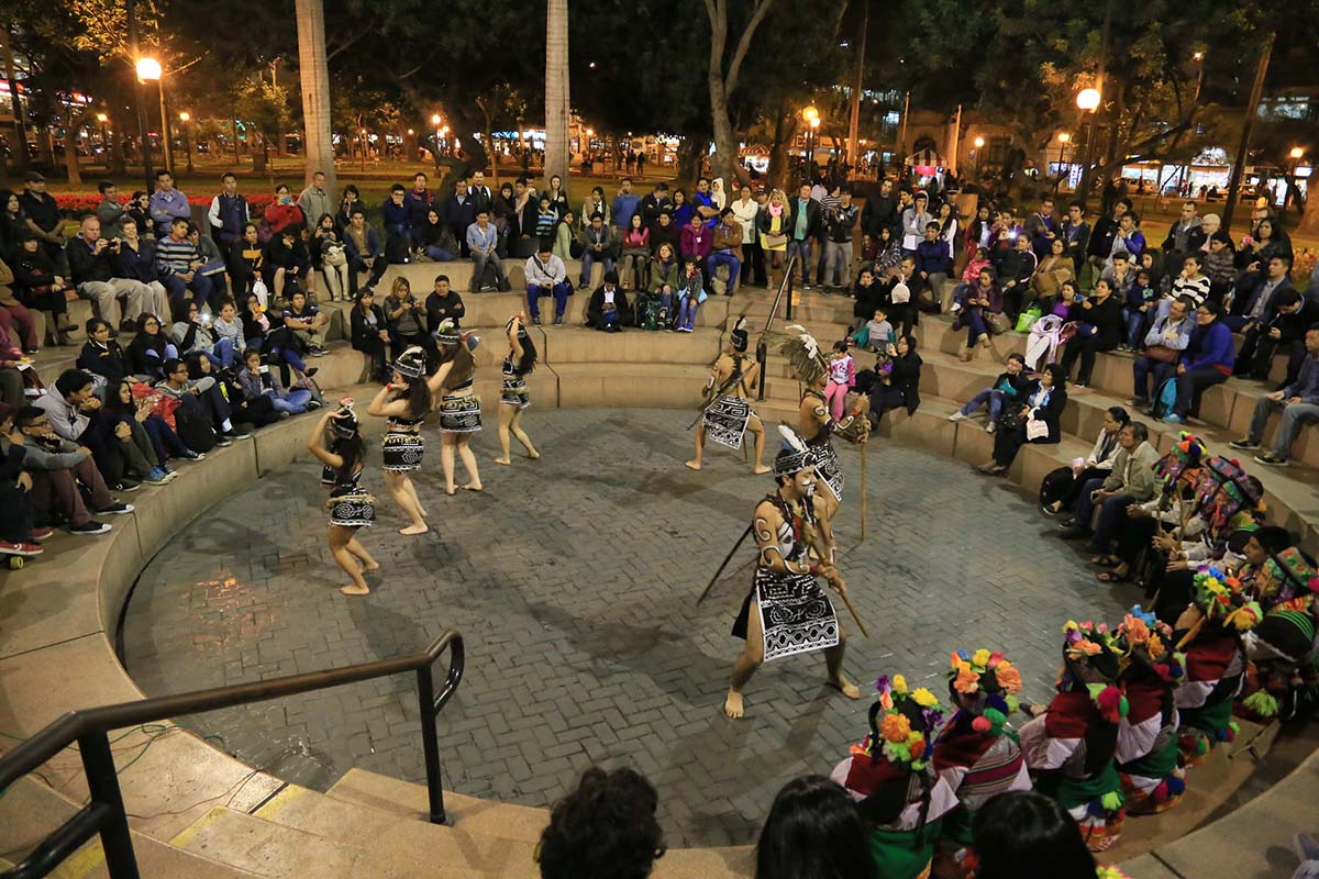 A group of seven dancers performing in the Chabuca Granda Ampitheater in Parque Kennedy.