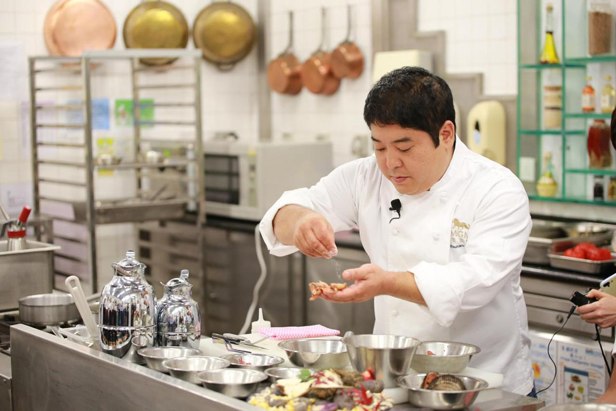 Famous Nikkei restaurant Maido's Chef Mitsuharu preparing food in his restaurant's kitchen.