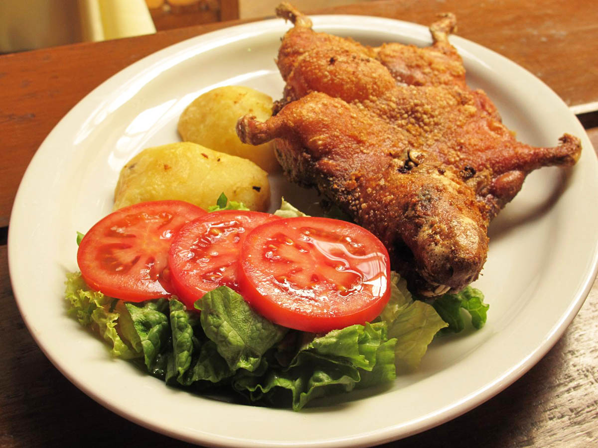 A whole fried guinea pig served with potatoes and salad is a Peruvian delicacy.