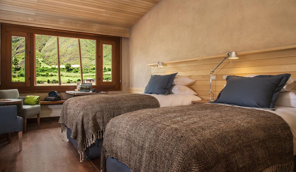 Contemporary room with natural elements and mountain vistas at Explora, a luxury Sacred Valley hotel