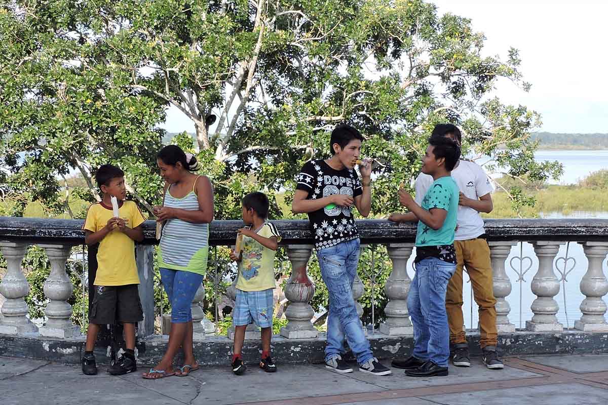 A family of 6 enjoys a snack on the Malecon Tarapaca in Iquitos, Peru.