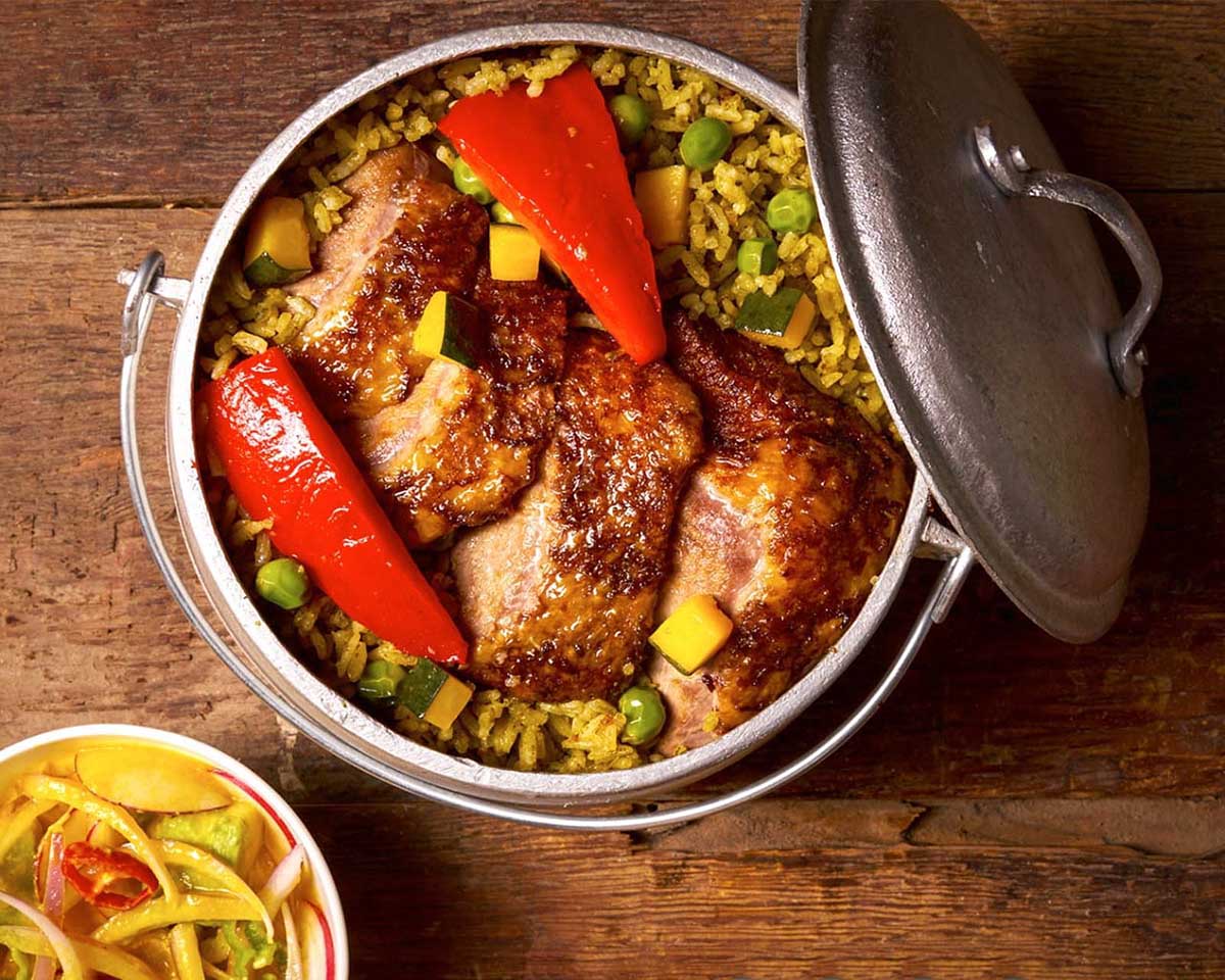 A pot full of duck, rice and vegetables known as arroz con pato, a staple of Northern Peru.