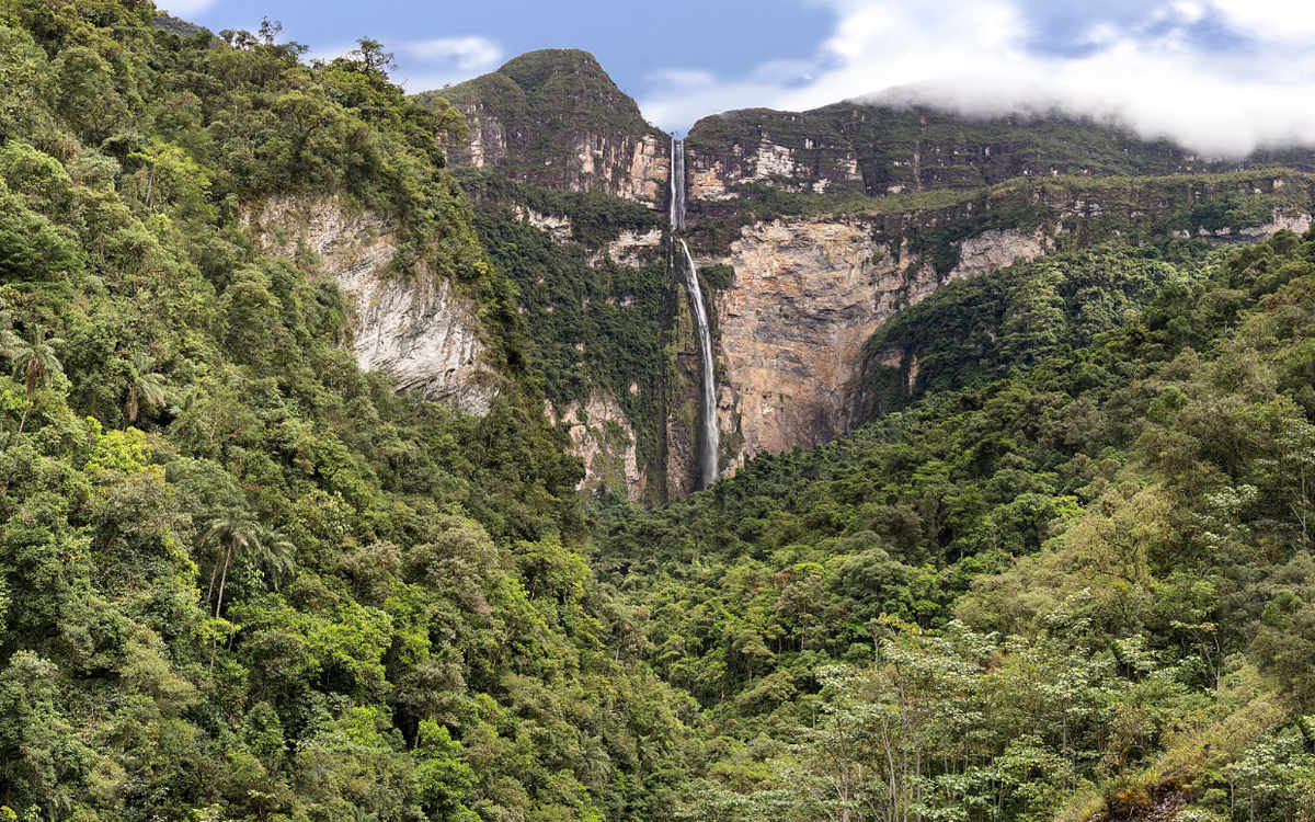 Gocta Falls in Peru is as tall as two empire state buildings and you trek green hills to get there.