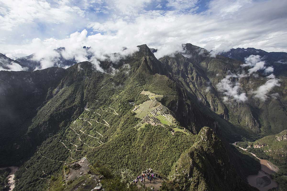 View of Machu Picchu from the Huayna Picchu summit on a partly cloudy day.