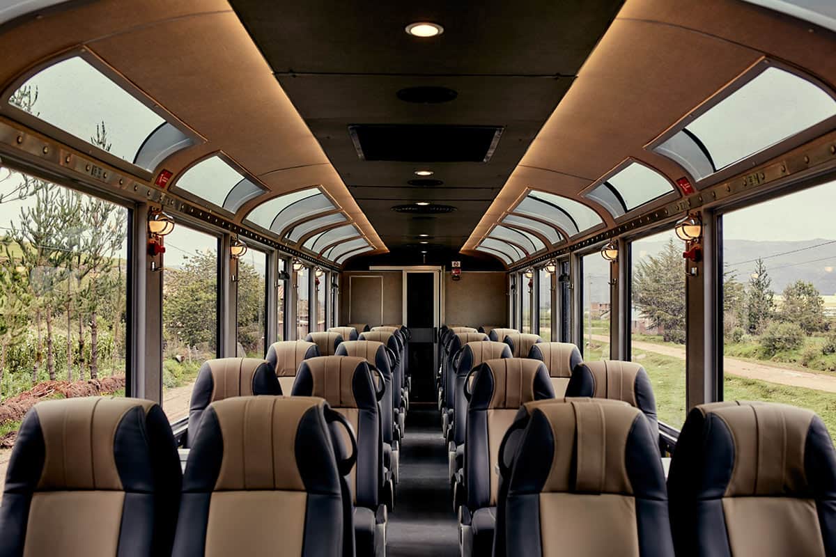 Inside the Inca Rail 360 Train with rows of comfortable seats and large panoramic windows.
