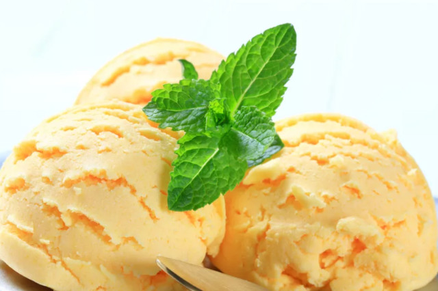 A close up of 3 scoops of lucuma ice cream, a popular Peruvian dessert.