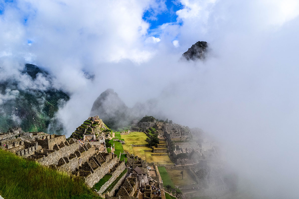 Machu Picchu mist wrapped around Huayna Picchu mountain, with stunning views of the ruins.