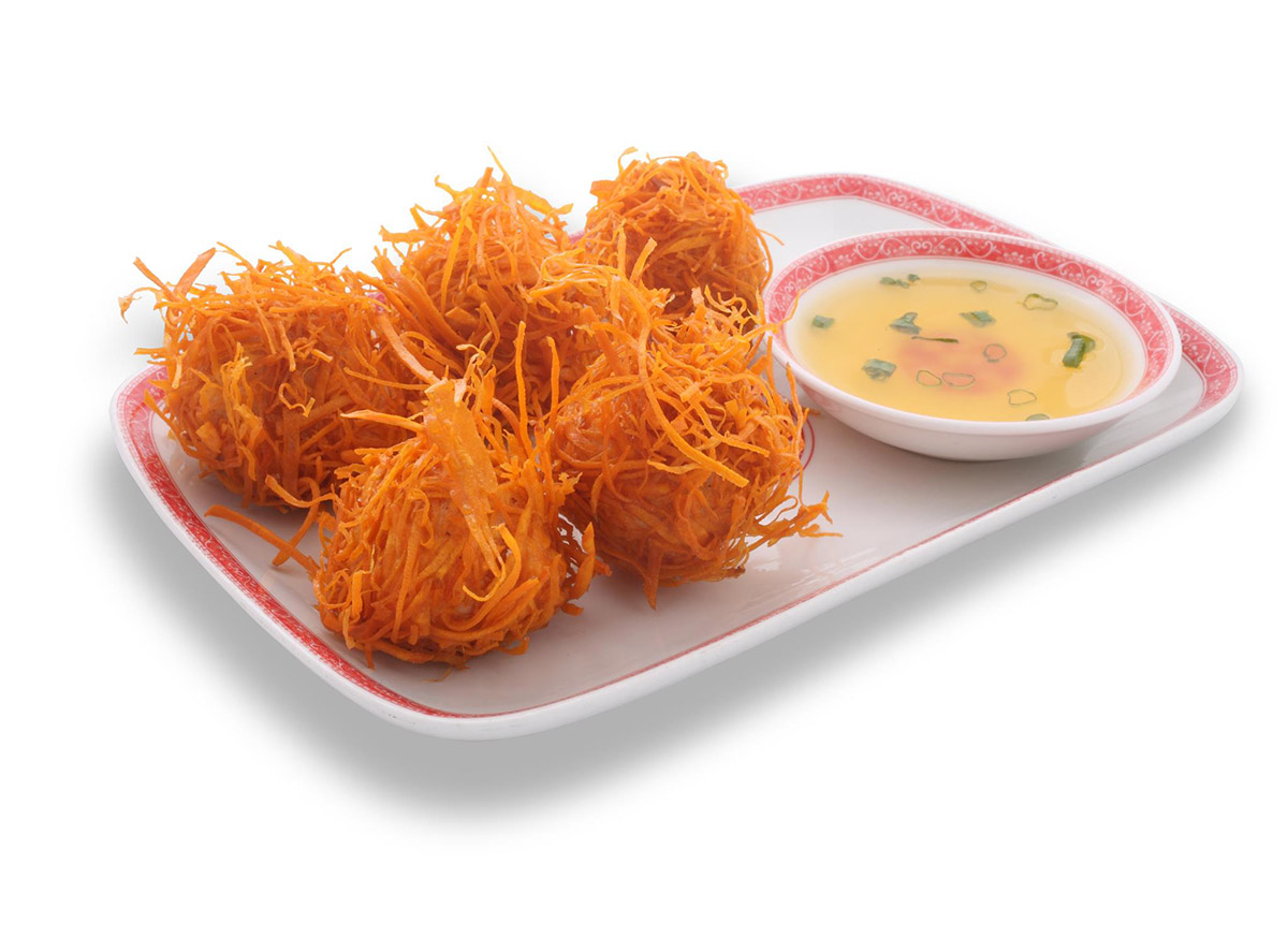 Five large orange balls of sweet potato with seafood inside and a yellow dipping sauce.