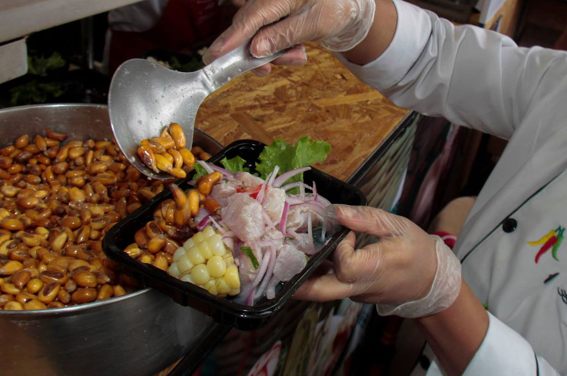Peruvian ceviche served with a side of choclo and canchita at the Mistura Food Festival in Lima.