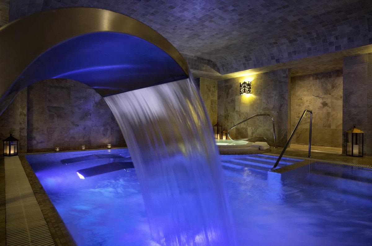 A indoor waterfall at the hydrothermal pools at Palacio del Inka spa resort in Peru.