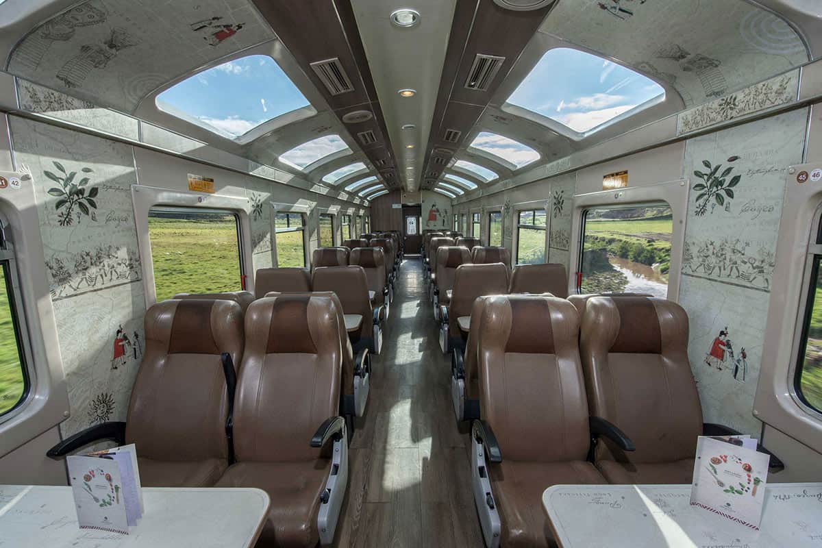 The rows of seats next to windows inside the PeruRail Vistadome Train to Machu Picchu.