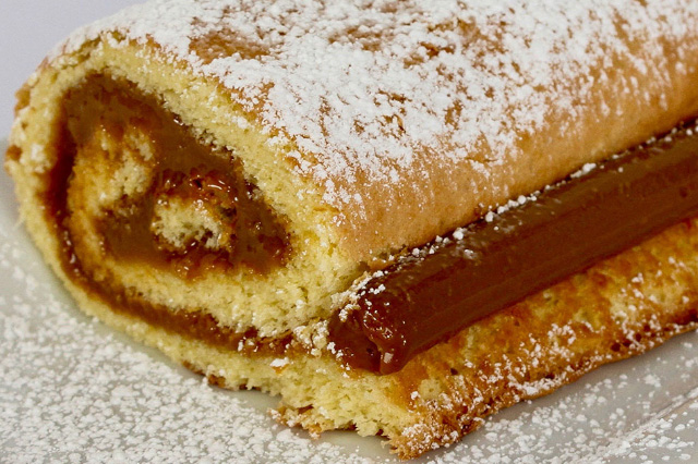 An upclose of the Peruvian dessert known as Pionono, with generous manjar blanco filling