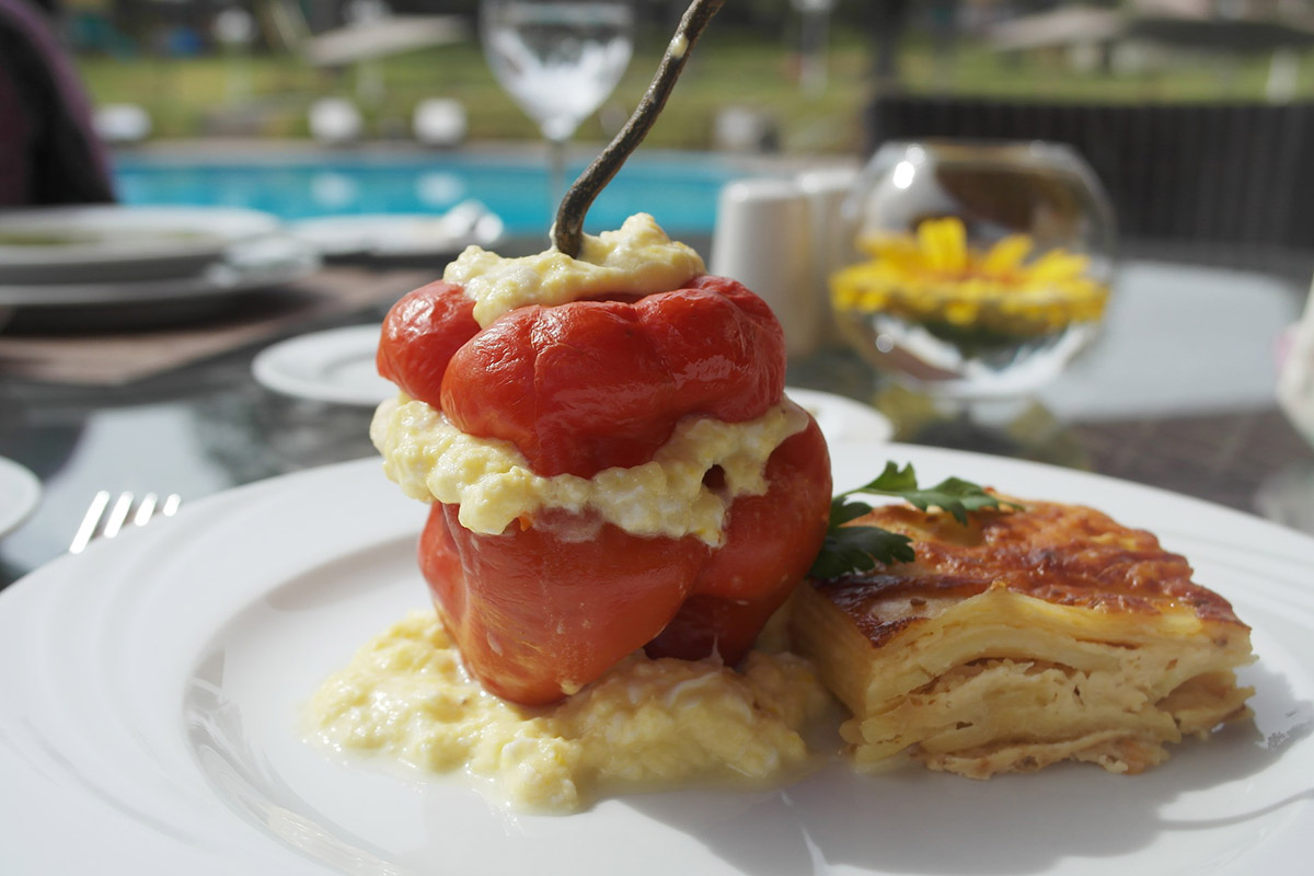 Stuffed red rocoto pepper with potato and cheese casserole, a common Peruvian food pairing.