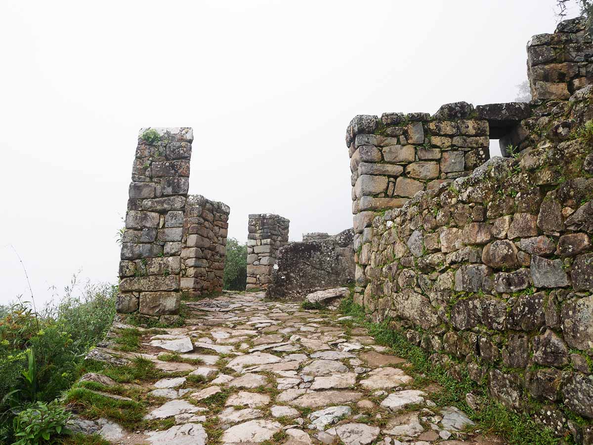 A stone walkway leads to stone walls that make up the Sun Gate, or Inti Punku, at Machu Picchu.