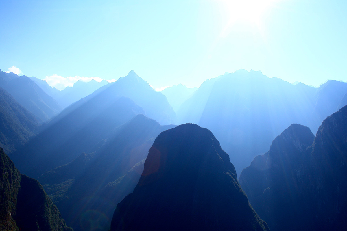 Beautiful sunshine over the Andes Mountains casting blue light and mysterious fog across the range.