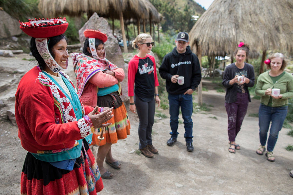 Tourists visiting Awamaki and receiving a short lecture by one of the local woman artisans.