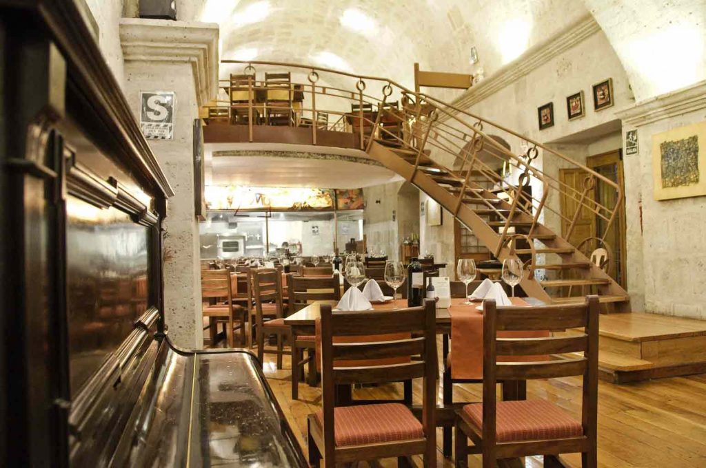 Interior shot of the Zingaro dining room, with piano in the foreground